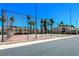 Community tennis courts surrounded by mature landscaping and palm trees at 2655 Aracatuba Ave, Las Vegas, NV 89121