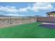 Fenced backyard with artificial turf and low-maintenance desert landscaping; mountain views at 2728 Tricase St, Henderson, NV 89044