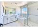 Bright bathroom featuring double sinks, a walk-in shower, and a soaking tub at 2728 Tricase St, Henderson, NV 89044