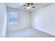 Neutral bedroom featuring plush carpeting, ceiling fan, and natural light from a single window at 2728 Tricase St, Henderson, NV 89044