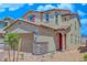 Inviting two-story home featuring a red door, neutral siding, and a well-manicured front yard at 2728 Tricase St, Henderson, NV 89044