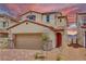 Inviting two-story home featuring a red door, neutral siding, and a well-manicured front yard at 2728 Tricase St, Henderson, NV 89044
