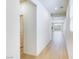 Hallway with light wood floors leading to a bright open-concept living room with mountain views at 2728 Tricase St, Henderson, NV 89044