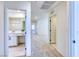 Hallway view to bathroom with ample lighting and neutral tile flooring at 2728 Tricase St, Henderson, NV 89044