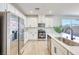 Bright white kitchen featuring stainless steel appliances and sleek countertops at 2728 Tricase St, Henderson, NV 89044