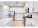 Bright white kitchen featuring stainless steel appliances and sleek countertops at 2728 Tricase St, Henderson, NV 89044