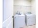 Efficient laundry room featuring a washer, dryer, and ample shelving for storage solutions at 2728 Tricase St, Henderson, NV 89044