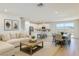 Open-concept living space with a white kitchen, neutral decor, and an adjacent dining area at 2728 Tricase St, Henderson, NV 89044