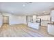 Bright open-concept living space featuring hardwood floors, modern lighting, and a white kitchen at 2728 Tricase St, Henderson, NV 89044