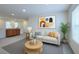 Bright living room features neutral tones, modern art, and ample natural light at 2728 Tricase St, Henderson, NV 89044