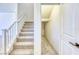 Carpeted stairs leading to the upper level, next to a small storage space with shelving at 2728 Tricase St, Henderson, NV 89044