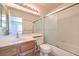 Bright bathroom with a shower/tub combination and a sliding glass shower door at 2738 Sandalwood Ave, Henderson, NV 89074