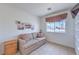 Bright bedroom with a comfortable couch, a window, and a built-in bookshelf at 2738 Sandalwood Ave, Henderson, NV 89074