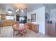Bright dining area next to kitchen with wood table, chandelier, and decorative accents at 2738 Sandalwood Ave, Henderson, NV 89074