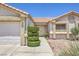 Well-maintained home exterior featuring a two-car garage and manicured front yard at 2738 Sandalwood Ave, Henderson, NV 89074