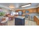 Open kitchen with island, stainless steel appliances, and tile flooring at 2738 Sandalwood Ave, Henderson, NV 89074