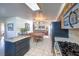 Open eat-in kitchen features dark cabinetry, a cooktop, and a view to the Gathering room at 2738 Sandalwood Ave, Henderson, NV 89074