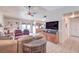 Open-concept living room with tile floors, abundant seating, and seamless flow to the kitchen at 2738 Sandalwood Ave, Henderson, NV 89074