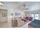 Comfortable living room featuring plush seating, a ceiling fan, and tile floors at 2738 Sandalwood Ave, Henderson, NV 89074