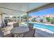 Covered patio offers shade near the sparkling pool, creating a perfect space for relaxation and outdoor dining at 2738 Sandalwood Ave, Henderson, NV 89074
