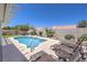 Beautiful backyard pool with lounge chairs and mature landscaping, offering a serene retreat at 2738 Sandalwood Ave, Henderson, NV 89074