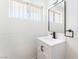 Stylish bathroom boasts a modern vanity with a sleek black faucet and bright lighting at 2878 El Cajon St, Las Vegas, NV 89169