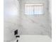Stylish bathroom featuring marble-like tiling, modern fixtures, and a bathtub at 2878 El Cajon St, Las Vegas, NV 89169