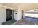 View of covered entryway to home with black security door and desert-friendly landscaping at 2878 El Cajon St, Las Vegas, NV 89169