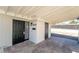 View of covered entryway to home with black security door and desert-friendly landscaping at 2878 El Cajon St, Las Vegas, NV 89169