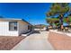 Exterior shot featuring desert landscaping, a covered carport, and modern design at 2878 El Cajon St, Las Vegas, NV 89169