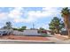 Street view of home with desert landscaping, covered carport, and mature trees at 2878 El Cajon St, Las Vegas, NV 89169
