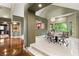 Elegant dining room with modern lighting, picture window, and neutral decor for sophisticated gatherings at 3004 Astoria Pines Cir, Las Vegas, NV 89107