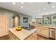Bright kitchen featuring stainless appliances, ample counter space, and an island with gas range at 3004 Astoria Pines Cir, Las Vegas, NV 89107