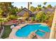 Expansive backyard pool area with lush greenery and various seating arrangements at 3004 Astoria Pines Cir, Las Vegas, NV 89107