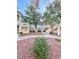 Multi-level condo with a desert landscaped yard, walkway, and mature trees at 3101 Casey Dr # 204, Las Vegas, NV 89120
