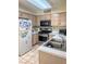 Functional kitchen with stainless steel appliances, tile flooring, and ample storage, ready for culinary enthusiasts at 3101 Casey Dr # 204, Las Vegas, NV 89120