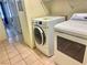 Modern laundry area with side-by-side washer and dryer units and tile flooring at 3101 Casey Dr # 204, Las Vegas, NV 89120