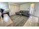Bright living room featuring hardwood-style floors, a gray sofa, and views from the front door at 3101 Casey Dr # 204, Las Vegas, NV 89120