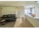 Cozy living room with a grey sectional sofa, neutral walls, and tile floors that lead to the front door at 3101 Casey Dr # 204, Las Vegas, NV 89120