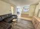 Inviting living room featuring a leather sofa, neutral walls, and tiled floors that flow into an adjacent room at 3101 Casey Dr # 204, Las Vegas, NV 89120