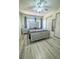 Spacious main bedroom with wood floors, sliding closet doors, and a modern bed frame at 3101 Casey Dr # 204, Las Vegas, NV 89120
