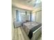 Spacious main bedroom with wood floors, sliding closet doors, and a modern bed frame at 3101 Casey Dr # 204, Las Vegas, NV 89120