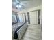 Spacious main bedroom with wood floors, sliding closet doors, and a modern bed frame at 3101 Casey Dr # 204, Las Vegas, NV 89120