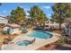 Community pool area featuring a pristine pool, hot tub, lounge chairs, and mature landscaping at 3101 Casey Dr # 204, Las Vegas, NV 89120