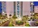 Grand entrance to the building with a circular drive, lush landscaping, and a porte-cochère at 322 Karen Ave # 2501, Las Vegas, NV 89109