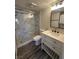 Bathroom featuring a stylish vanity, a marble-look shower, and gray wood-look tile floors at 3681 Melonies Dr # 29, Las Vegas, NV 89103