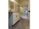 Bathroom boasts a shower-tub combo with marble tile, modern vanity, and wood-look tile flooring at 3681 Melonies Dr # 29, Las Vegas, NV 89103