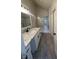 Bathroom features gray wood-look tile, a shower with marble-look tile, and a granite countertop at 3681 Melonies Dr # 29, Las Vegas, NV 89103
