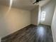 Bedroom features gray wood-look floors, a ceiling fan, and natural light from a window at 3681 Melonies Dr # 29, Las Vegas, NV 89103