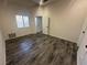 Bedroom with gray wood-look floors, a bright window, and a white paneled door at 3681 Melonies Dr # 29, Las Vegas, NV 89103